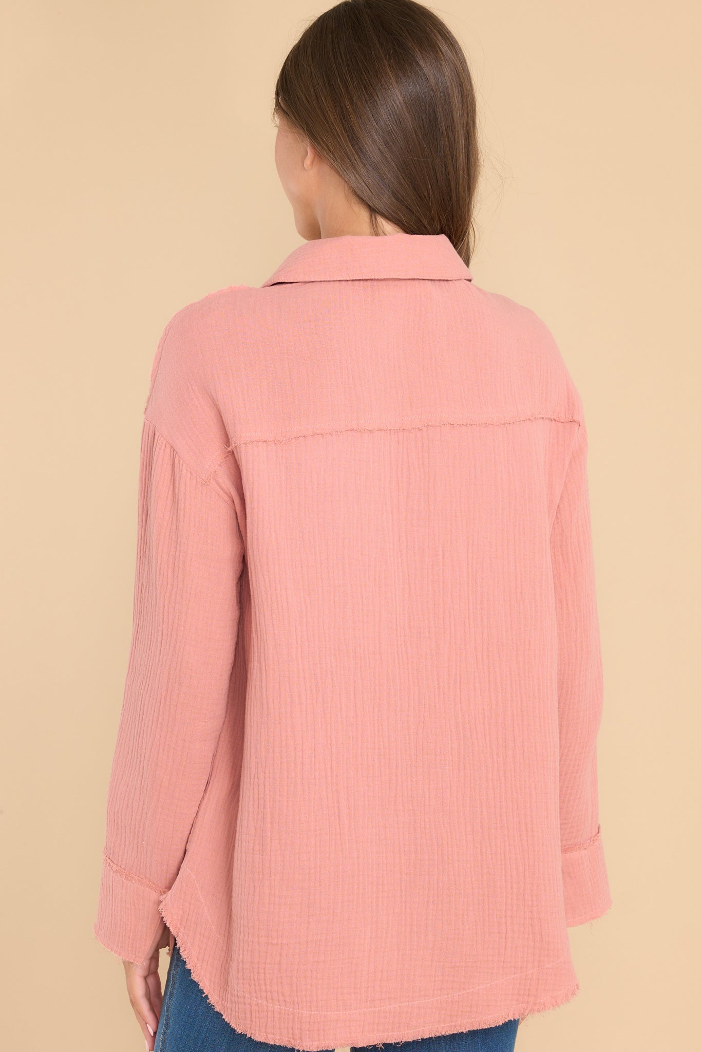 Back view of this top that features a collared neckline, buttons down the front, and two pockets on the bust.
