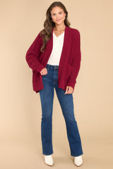 Full body view of this cardigan that features a soft chunky knit design, functional pockets, and small slits up the sides.