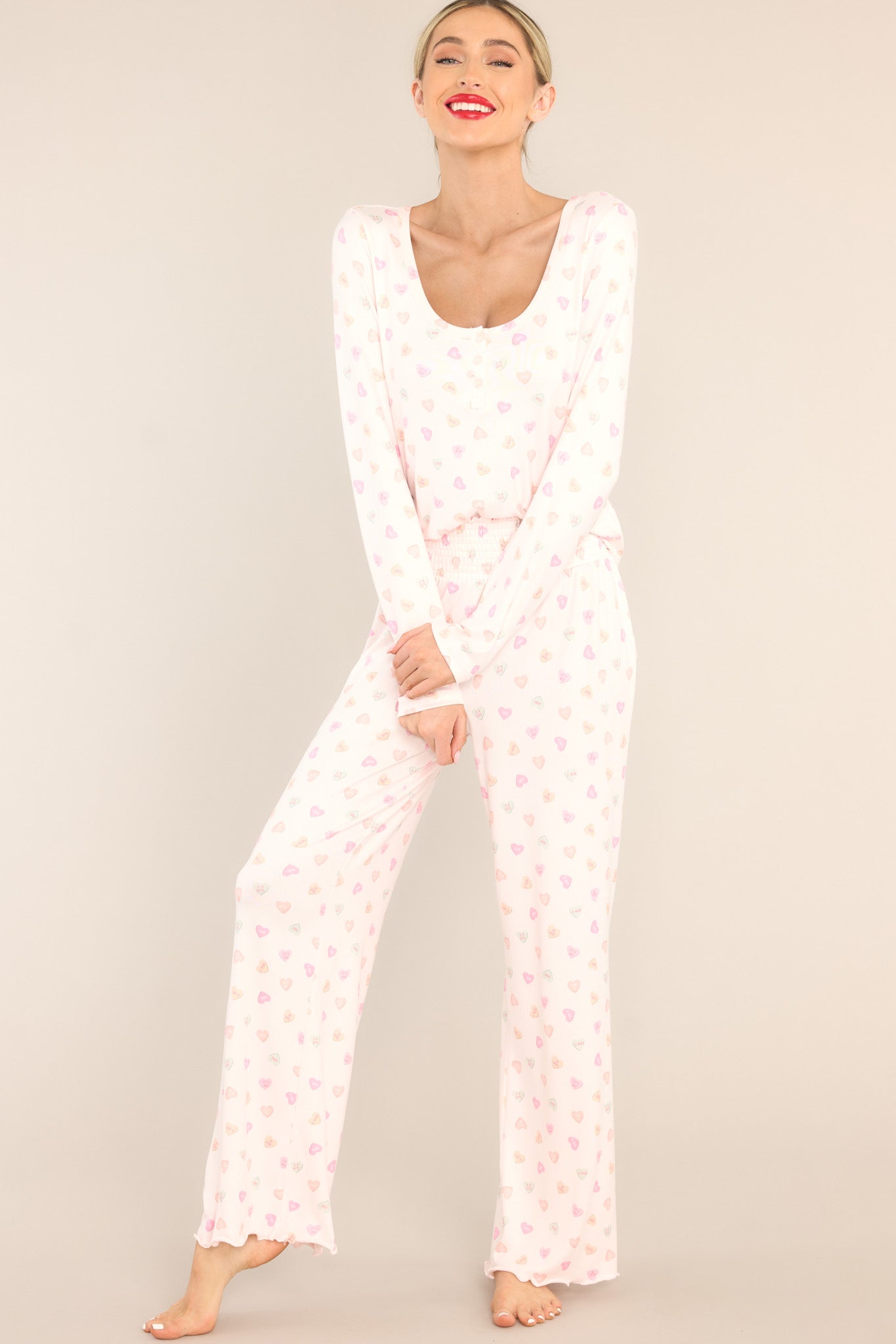 Full body view of these lounge pants that feature a fully smocked waistband, a festive print, and a super soft material.
