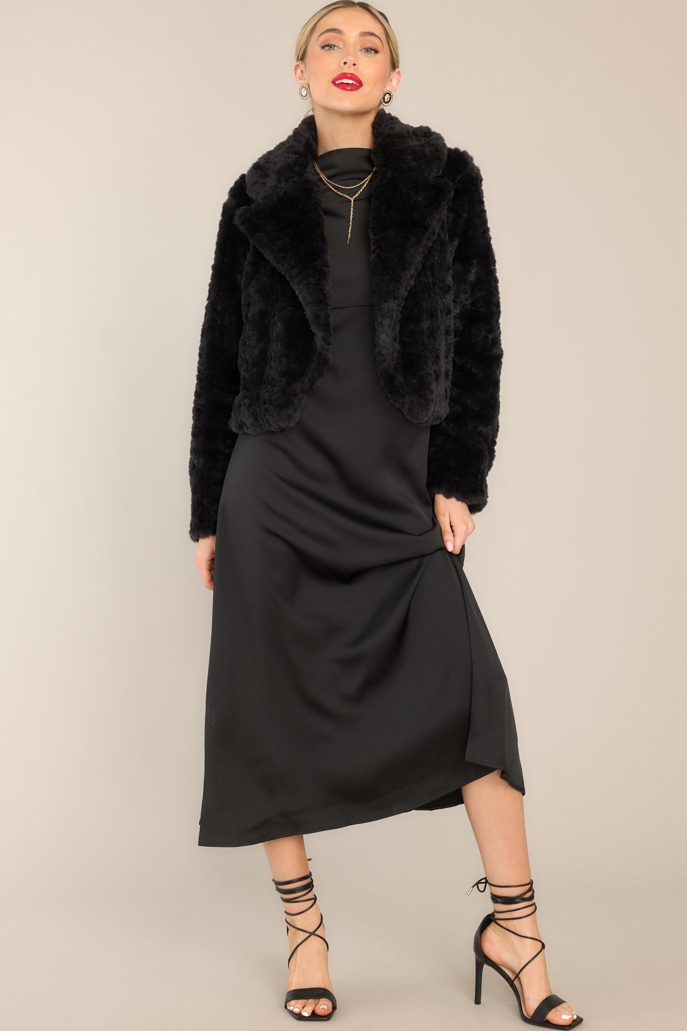 Full body view of this faux fur jacket that features a folded collar.
