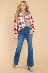 Full body view of this shirt that showcases a plaid patterns in shades of red and blue.