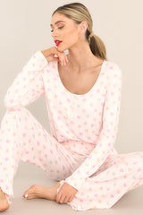 Close up view of these lounge pants that feature a fully smocked waistband, a festive print, and a super soft material.