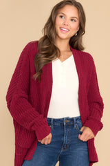 Front view of this cardigan that features a soft chunky knit design, functional pockets, and small slits up the sides.