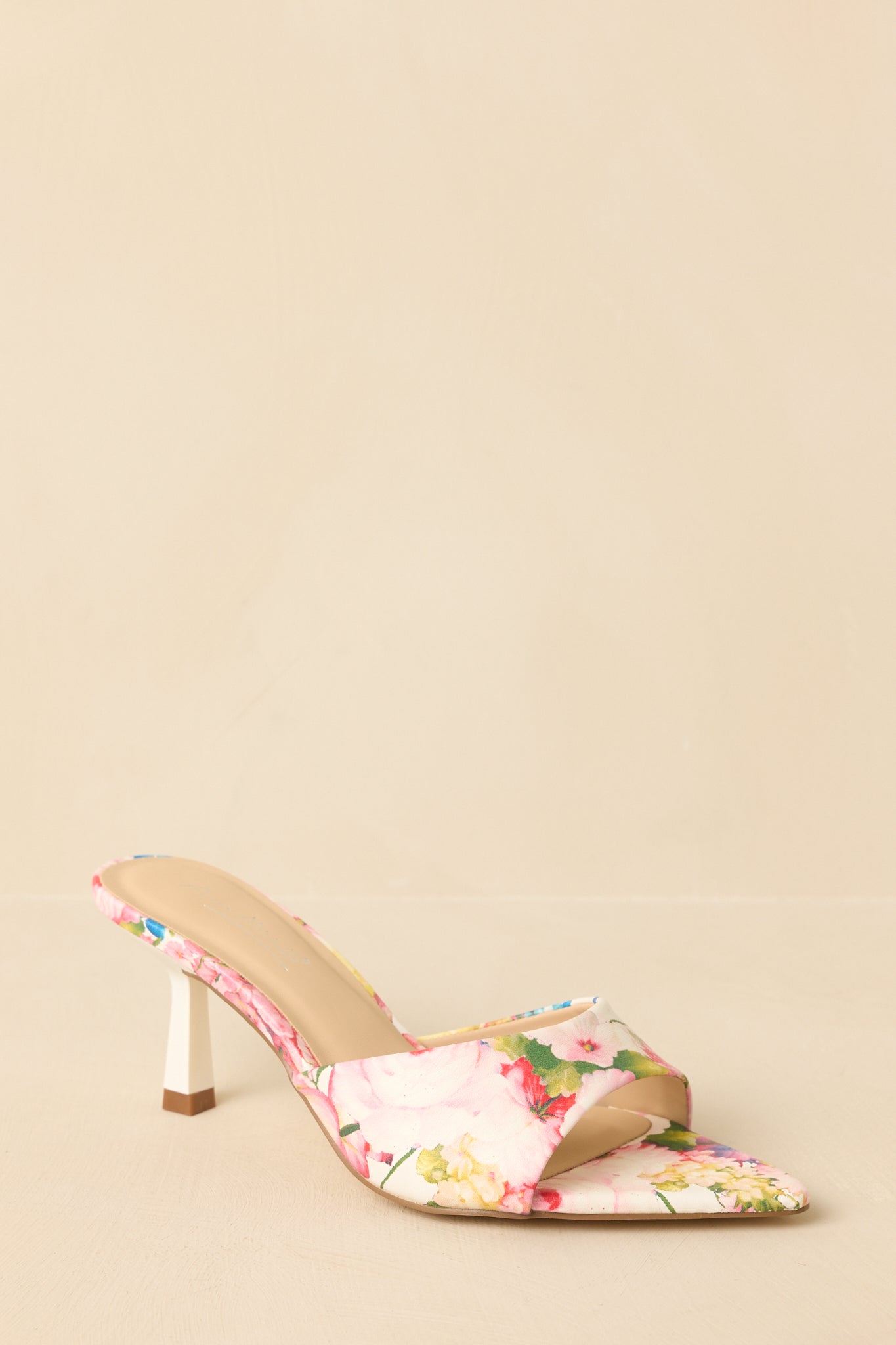 Three-quarter angle showcasing floral print and elegant mule silhouette.