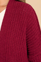 Close up view of this cardigan that features a soft chunky knit design.