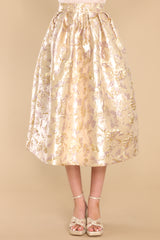 Front view of  this skirt that features a high waist, raised gold flower details, and a hemmed bottom.