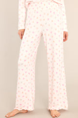 These ivory and light pink lounge pants feature a fully smocked waistband, a festive print, and a super soft material.