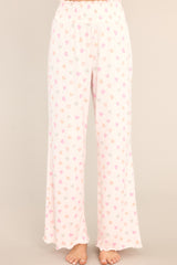 Front view of these lounge pants that feature a fully smocked waistband, a festive print, and a super soft material.