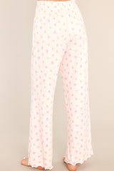 Back view of these lounge pants that feature a fully smocked waistband, a festive print, and a super soft material.