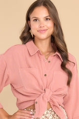 Front view of this top that features a collared neckline, buttons down the front, and two pockets on the bust.