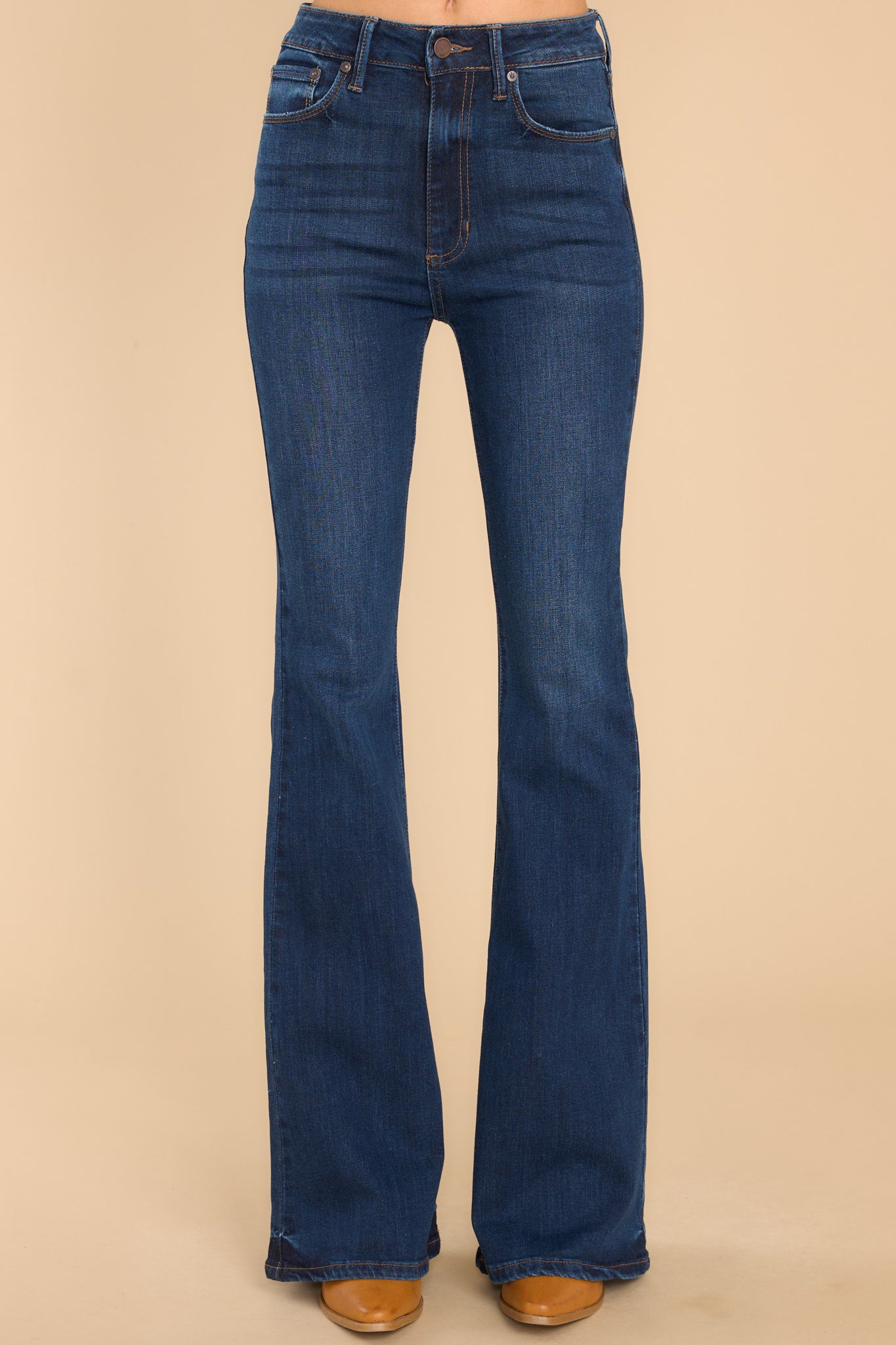 Front view of these jeans that feature a high waist fit, belt loops, zipper and button closure, functional pockets, and a bell bottom flare.