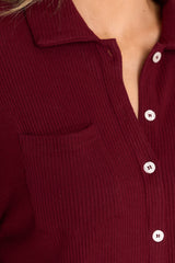 Close up view of this top that features button-down closures on the front, a collared neckline, cuffed sleeves, and a chest pocket.