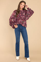 Full body view of this top that showcases the pink floral print on a burgundy fabric.