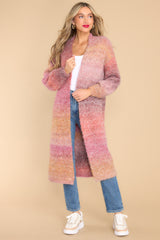 Full body view of this cardigan that features a multicolored design, elastic cuffed sleeves, and a soft material.