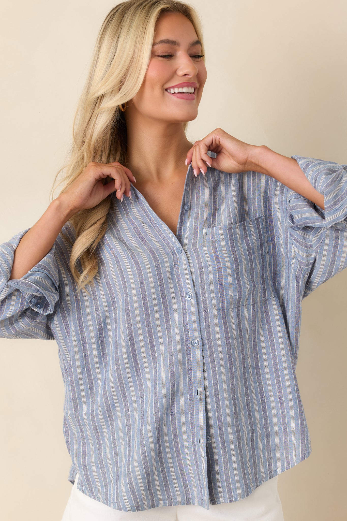 Collared neckline and indigo stripe pattern with visible button front detail.