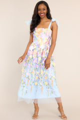 Front view of this dress features a square neckline, tulle ribbon self-tie straps, a hidden zipper at the back, and an embroidered floral design throughout the dress.