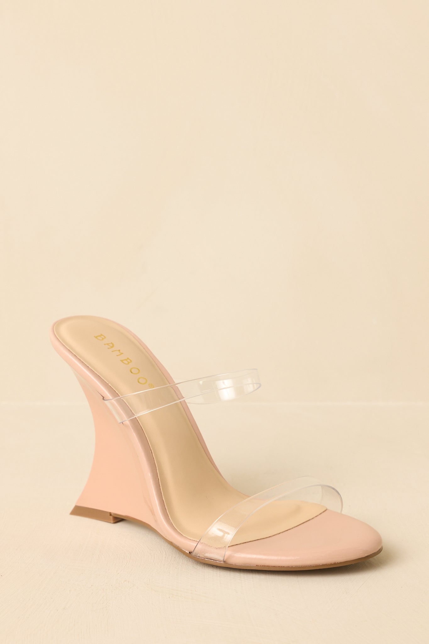 Wedge heels shown from a low angle emphasizing the contoured sole and smooth finish.