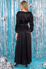 Back view of  this dress that features a high neckline with rhinestone detailing along the sleeves, a keyhole cutout at the back of the neck with a button closure at the top and a zipper below, and a slit down the left side of the skirt.