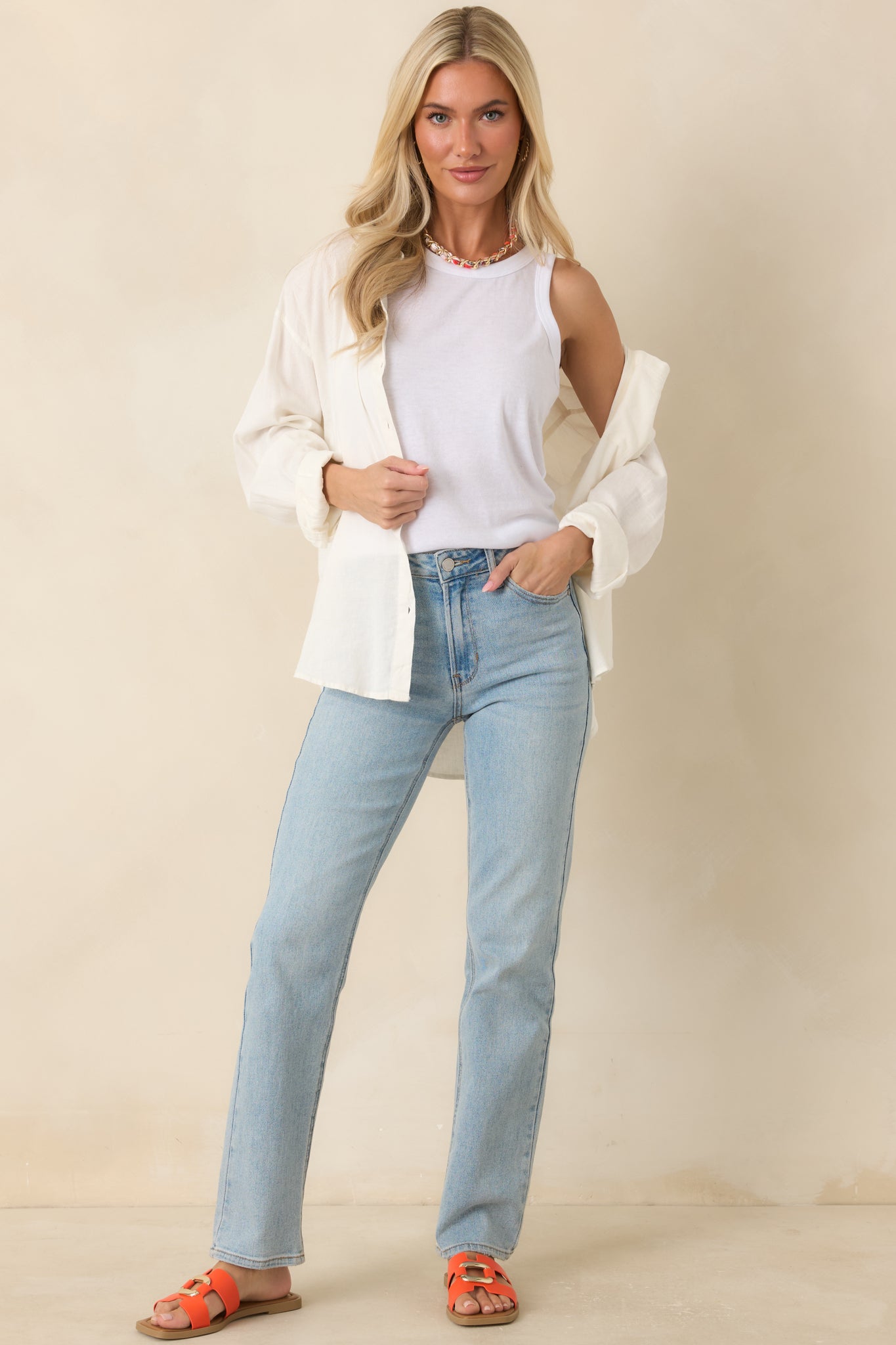 White sleeveless tank top featuring a smooth fitted silhouette, classic neckline, and versatile everyday design.