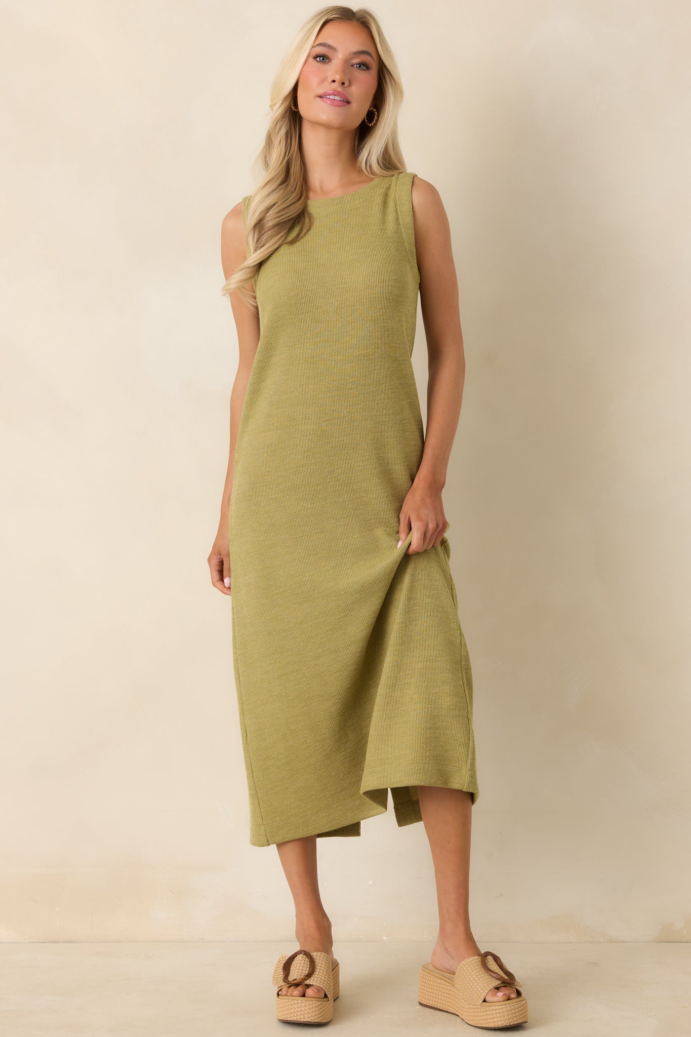 Midi-length olive dress showcasing soft ribbed fabric and a clean, minimalist silhouette.