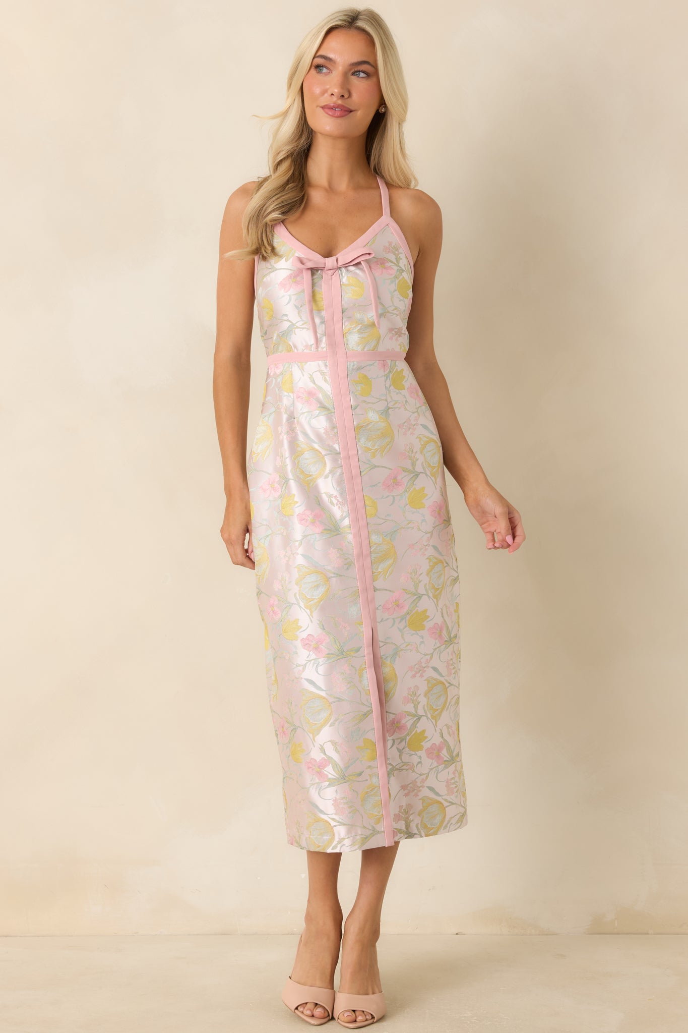 Floral jacquard midi dress in pink tones with adjustable spaghetti straps, a decorative bow neckline detail, and a subtle lustrous finish.