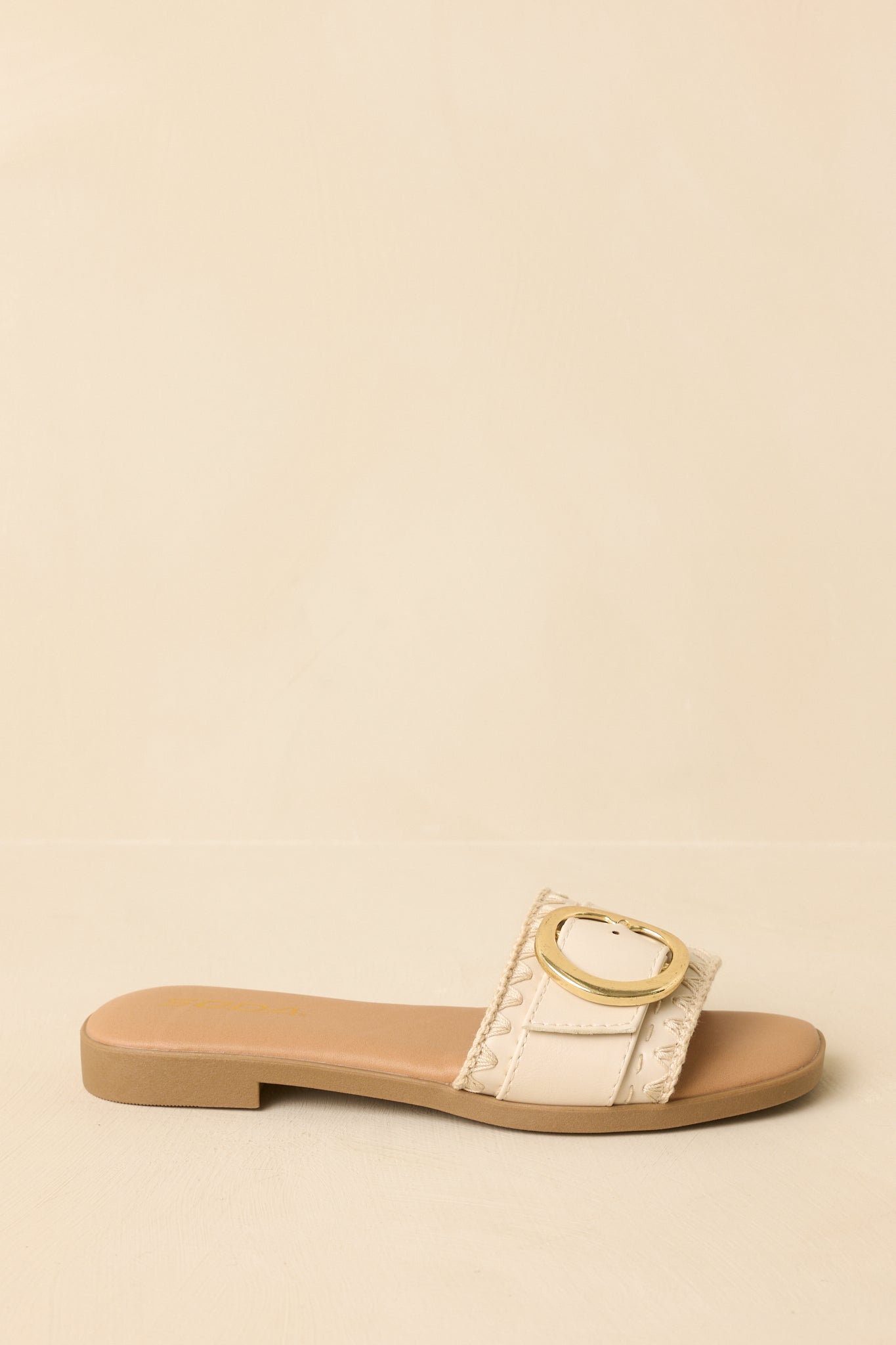Slide sandals shown from a low angle emphasizing the smooth footbed and clean strap lines.