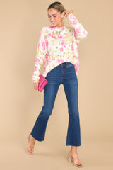 Full body view of this sweater that features a crew neckline, an all over floral print, and cuffed sleeves.