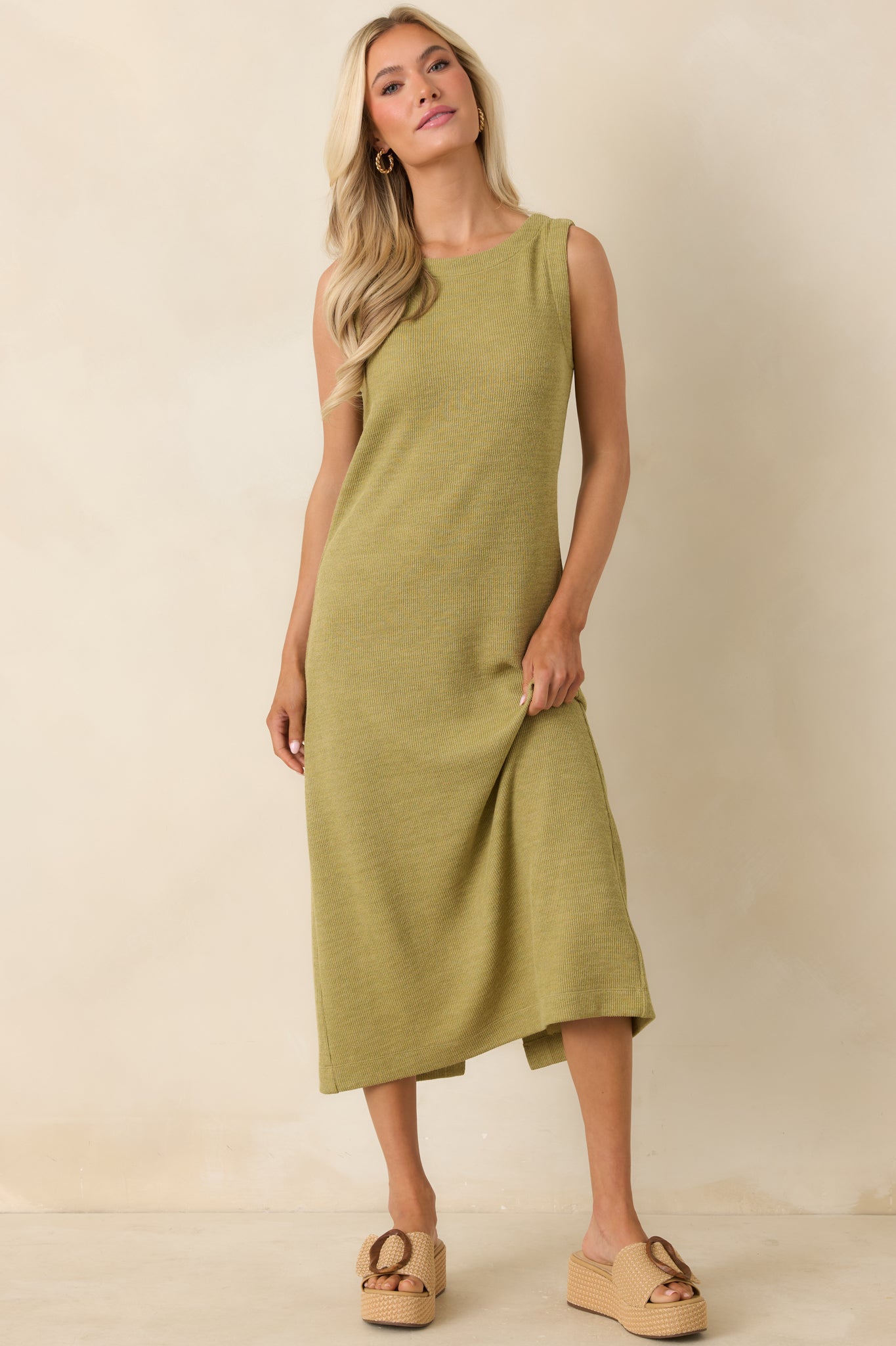 Olive green knit midi dress featuring a sleek sleeveless cut and versatile everyday styling.