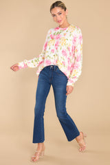 Full body view of this sweater that showcases the pink floral pattern of the fabric.
