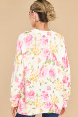 Back view of this sweater that features a crew neckline, an all over floral print, and cuffed sleeves.