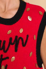 Close up view of this sweater vest that features a crew neckline and shiny football sequins.