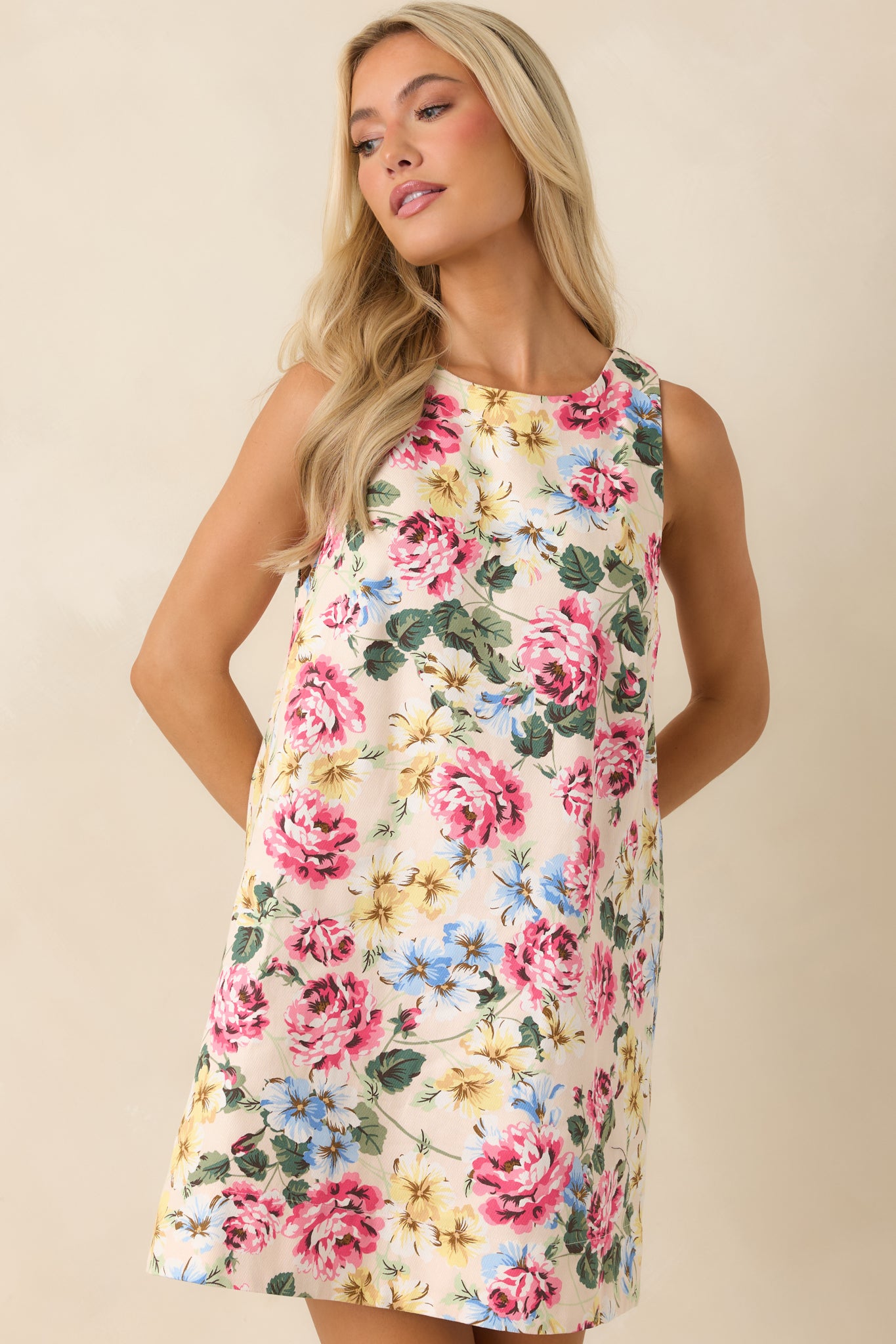 Ivory floral mini dress focusing on the vibrant vintage-inspired print with detailed floral placement across the structured fabric.