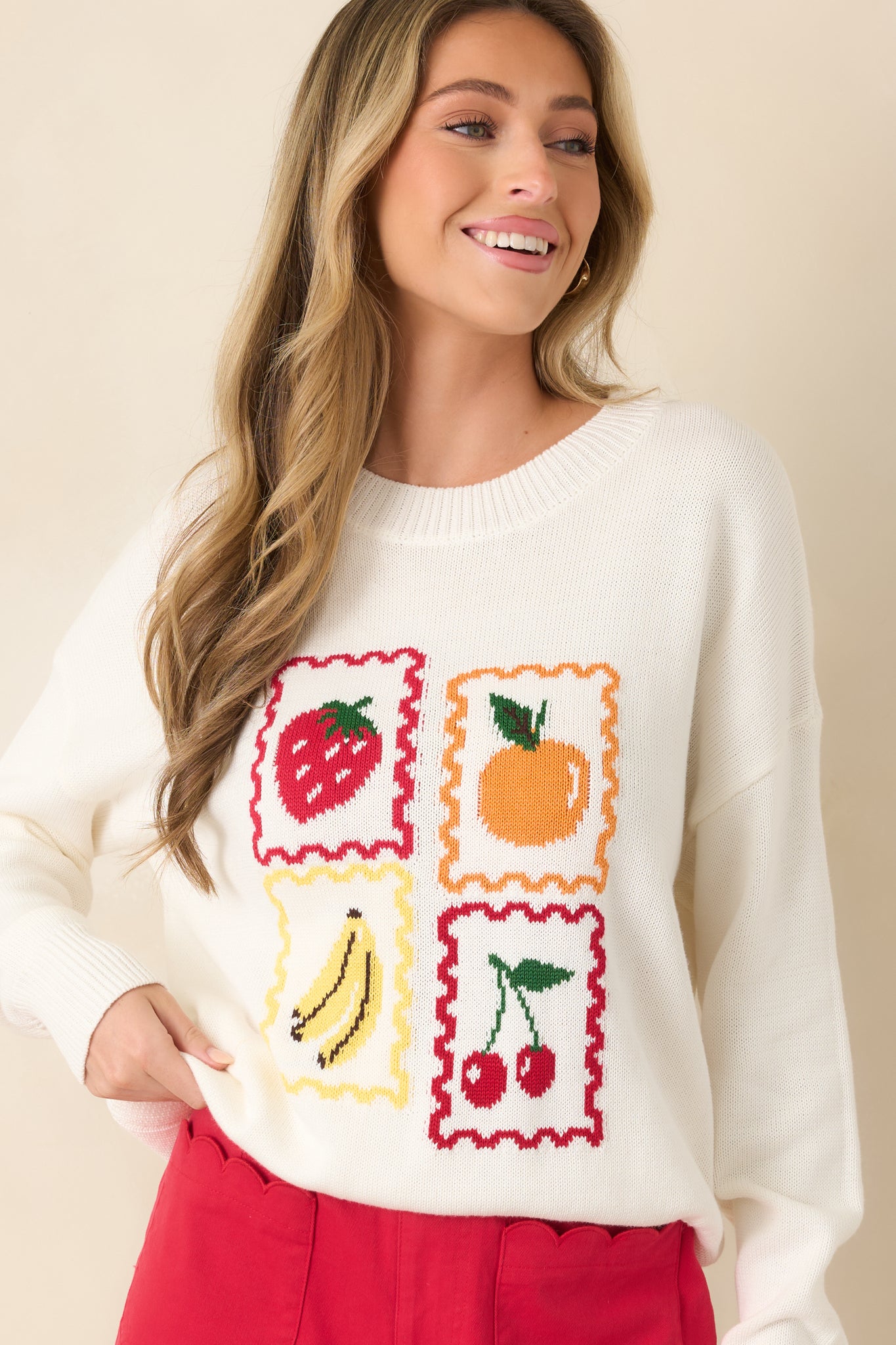 Cropped detail highlighting vibrant fruit prints against a cozy knit texture.