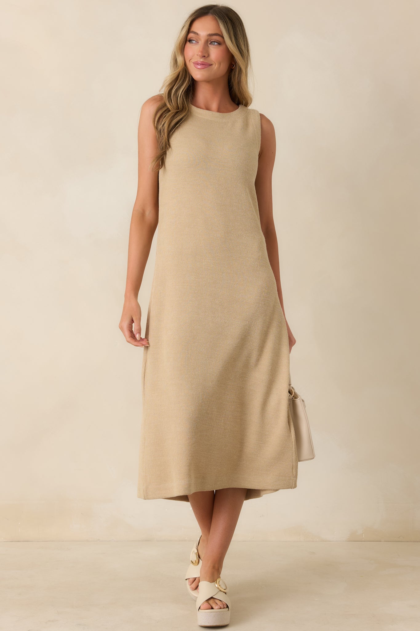 Natural midi dress with a sleeveless silhouette, rounded neckline, and soft rib knit texture.