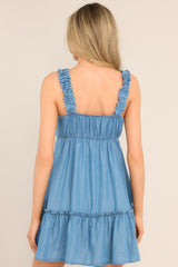 Back view of this dress that features a v-neckline, ruffed elastic straps, an elastic back insert, and a tiered design.