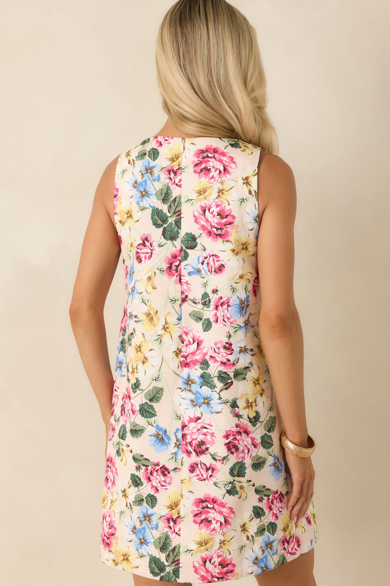 Ivory floral mini dress from the rear, showing the concealed back zipper closure and a clean, uninterrupted shift silhouette.