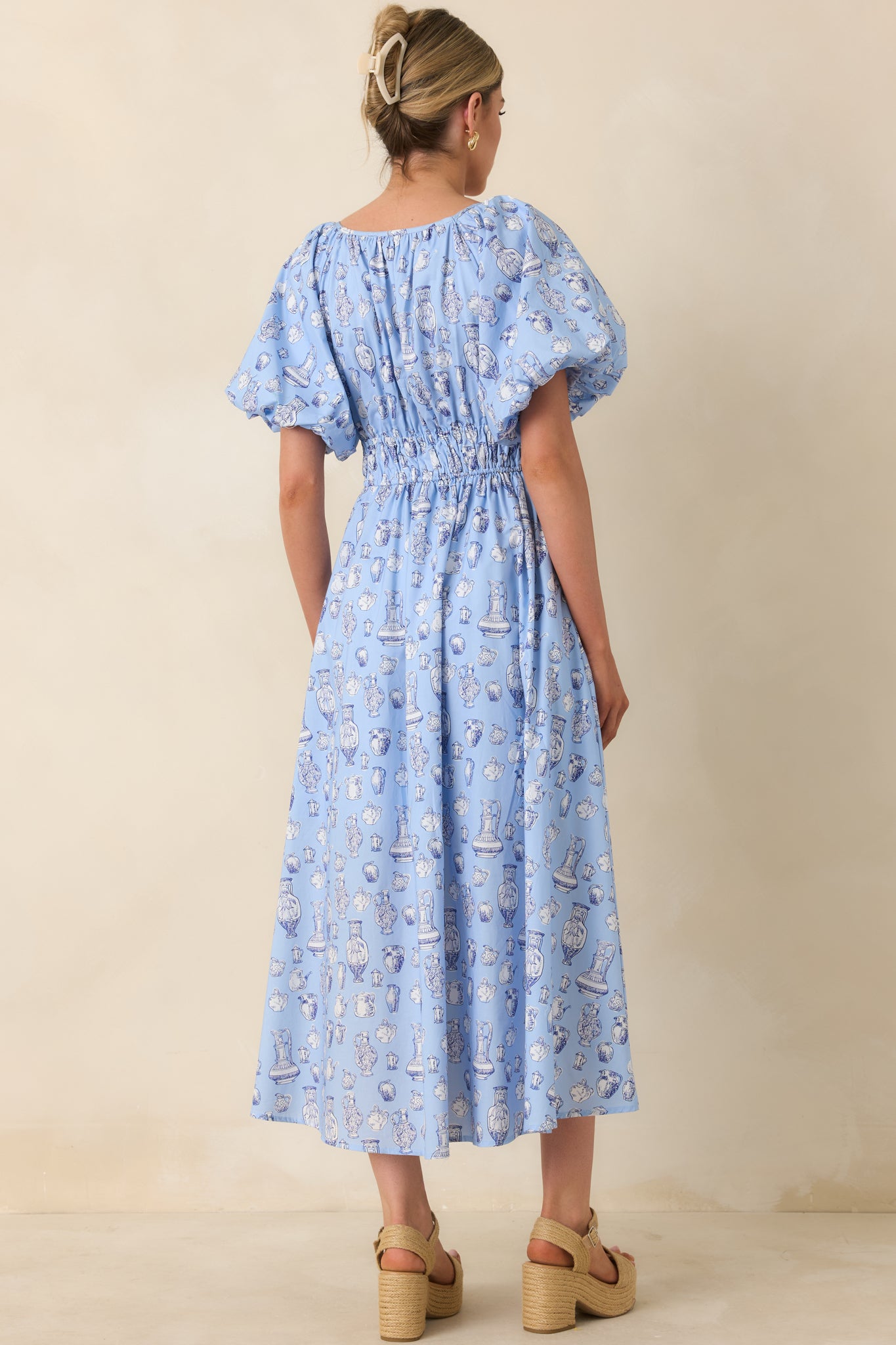 Rear view of midi dress with smocked waist, puff sleeves, and vintage-inspired toile pattern.