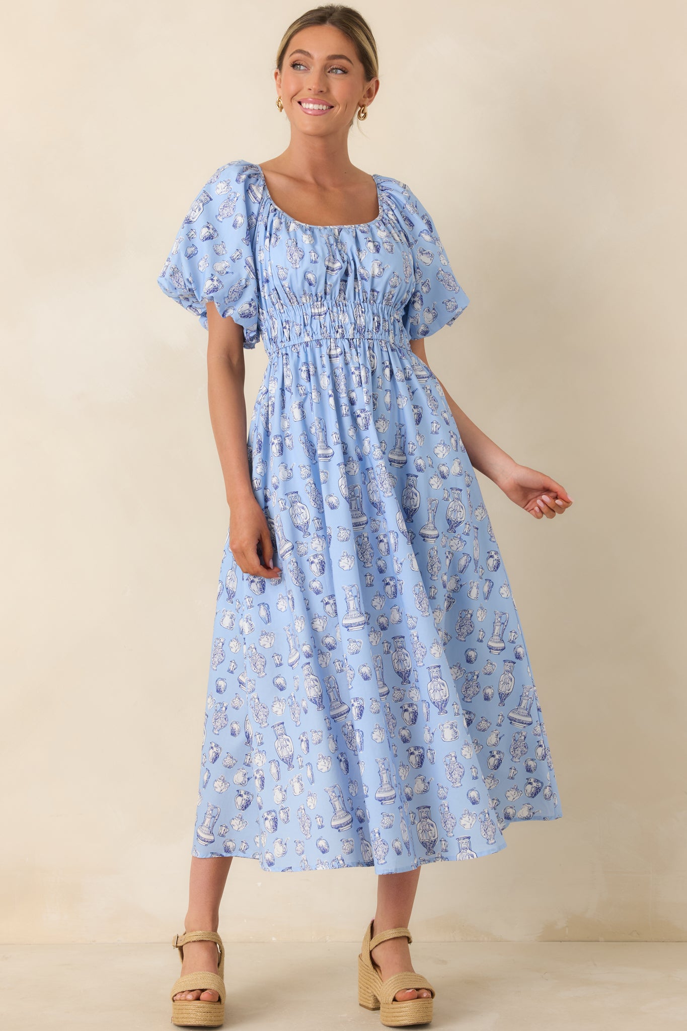 Cotton dress with vintage-inspired toile pattern, puff sleeves, and flattering smocked waist.