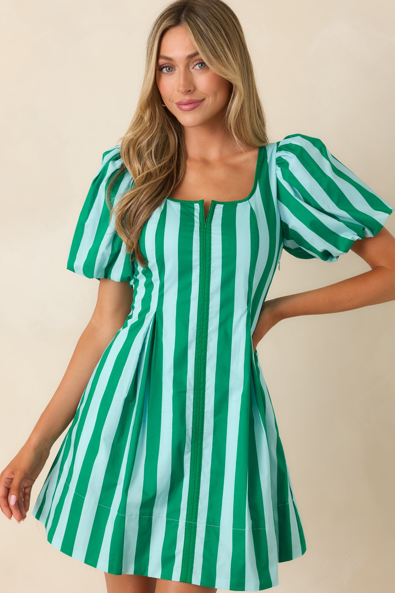 Close framing of the waistline and silhouette transition from fitted bodice to flared hem in breathable cotton.