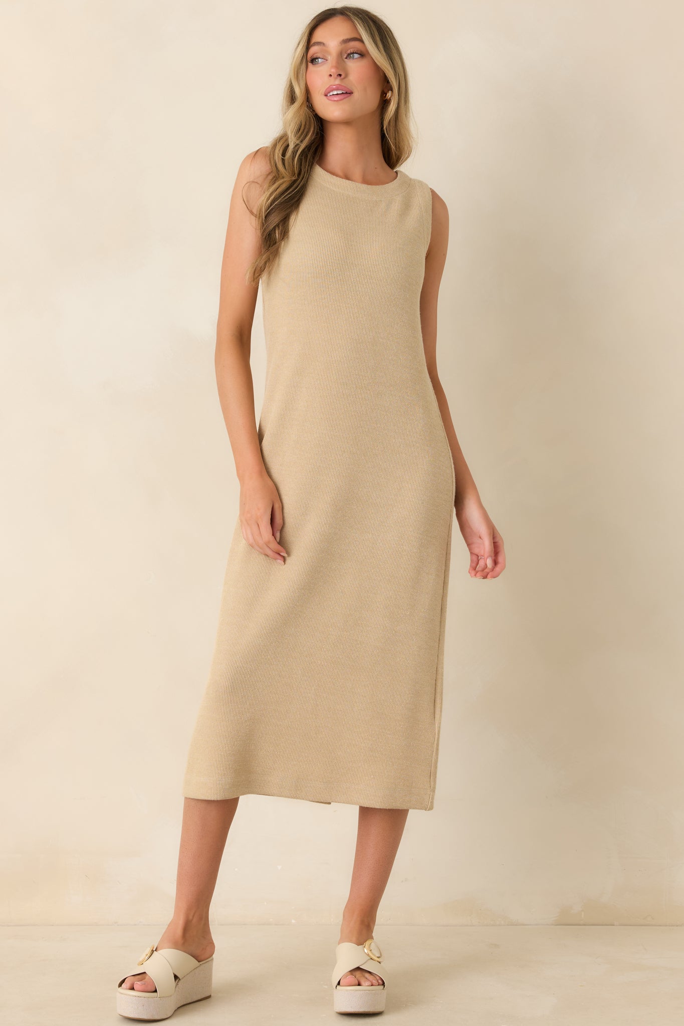 Soft knit midi dress in a natural hue featuring a versatile sleeveless style and refined shape.