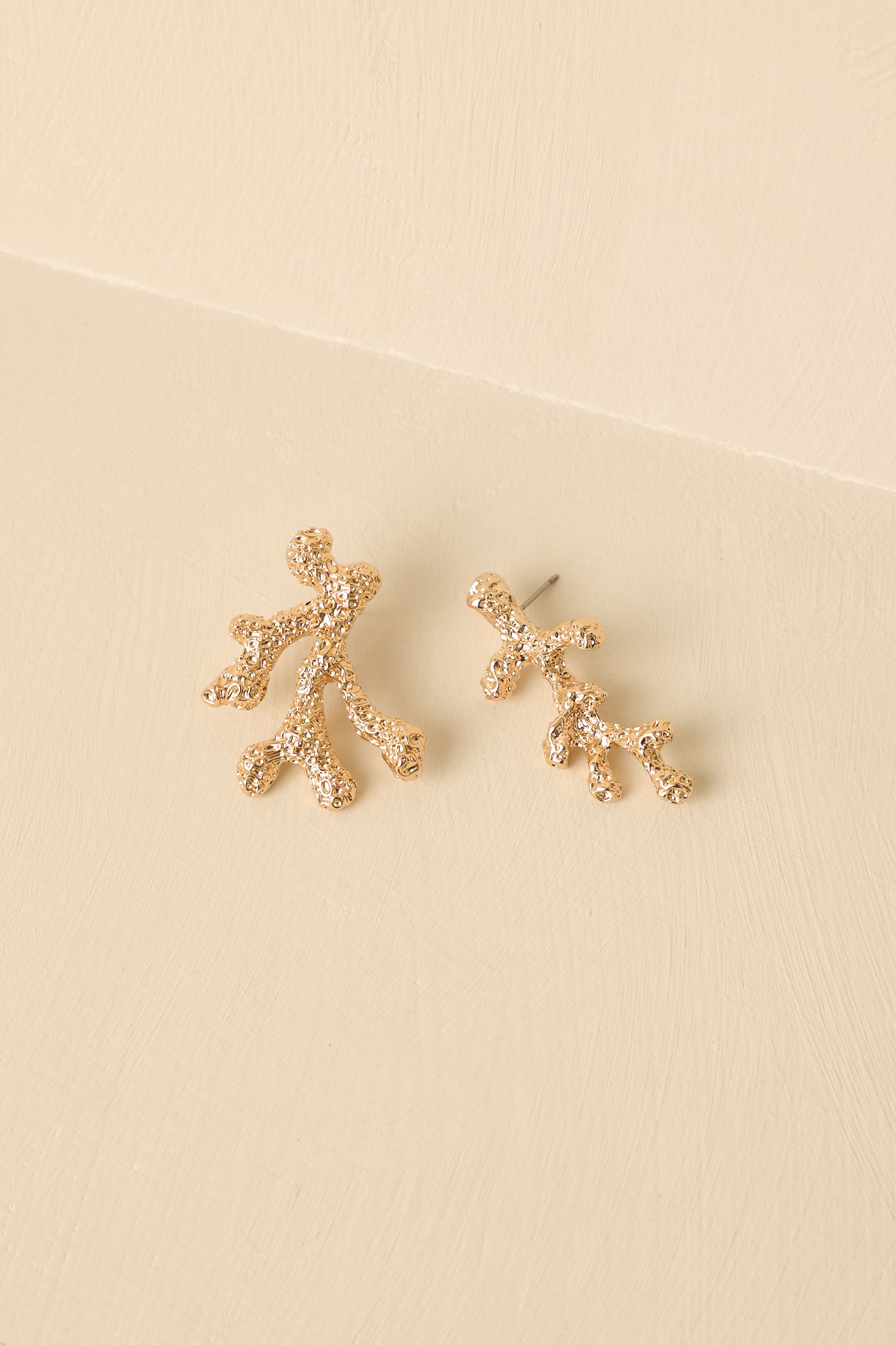 Close-up detail of the gold-tone coral branch earrings showing the intricate texture, dimensional form, and post-back closure.