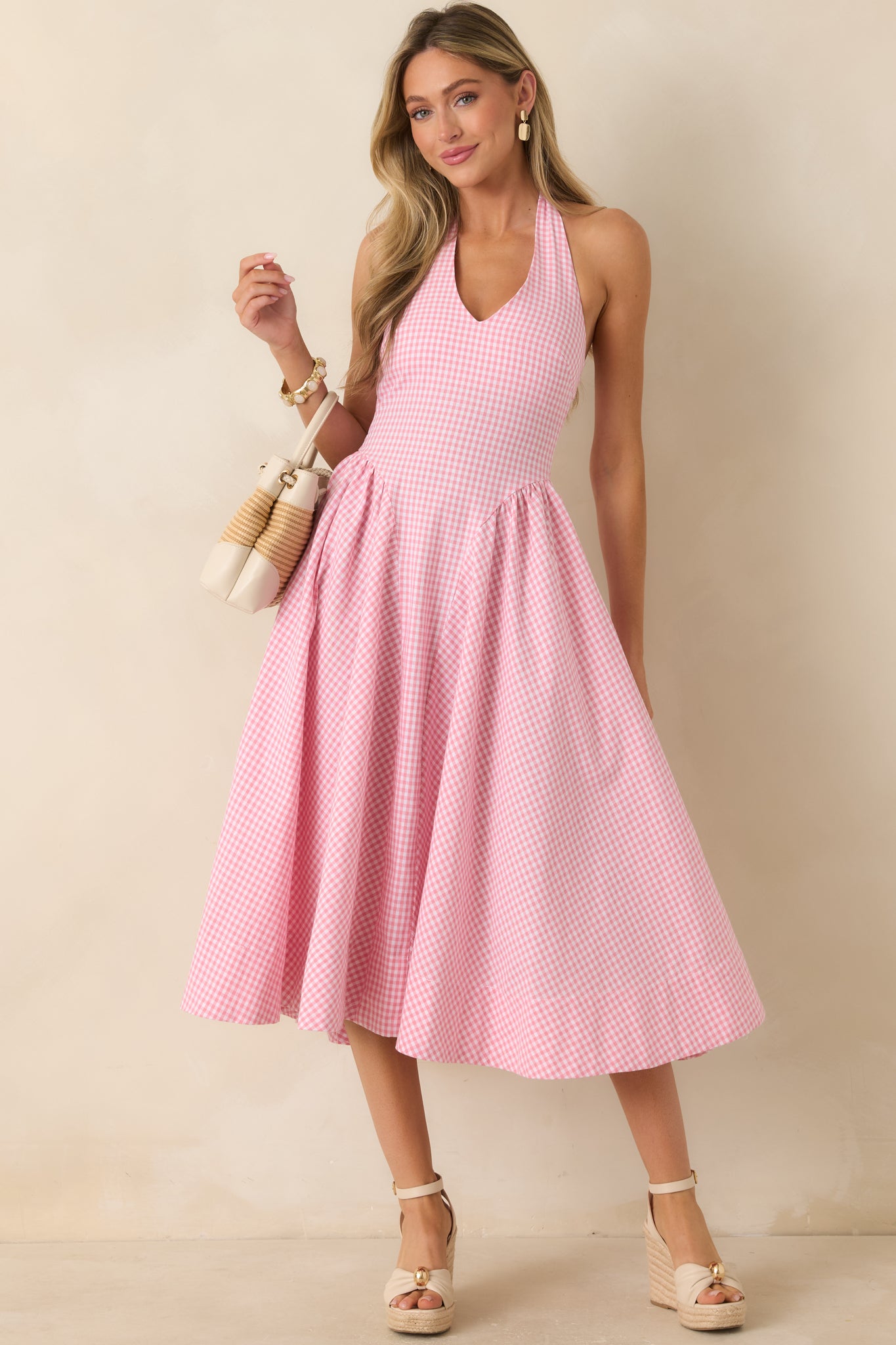 Lightweight midi dress with a halter neckline, fitted upper shape, and concealed back zipper closure for a clean finish.