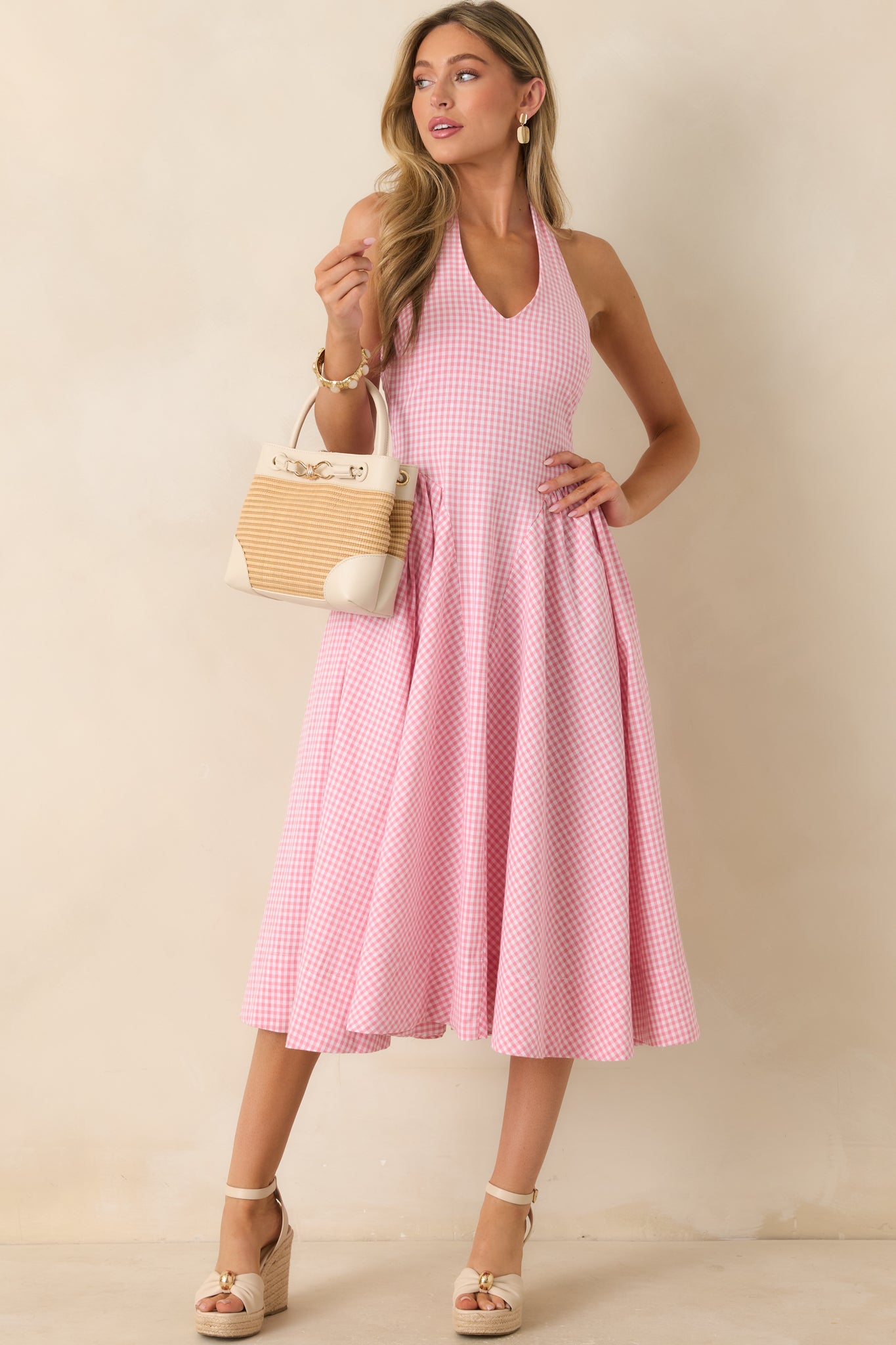 Pink gingham dress featuring a polished silhouette with a full skirt, structured bodice, and timeless woven cotton texture.