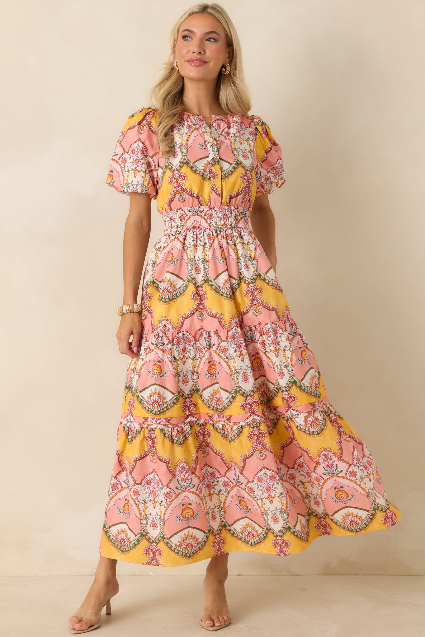 Pink and marigold printed midi dress with voluminous bubble sleeves, a tiered silhouette, and a softly gathered waist for comfortable shaping.