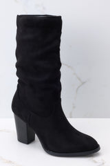 Close up view of these suede boots that feature a slouchy ankle design and a block heel.