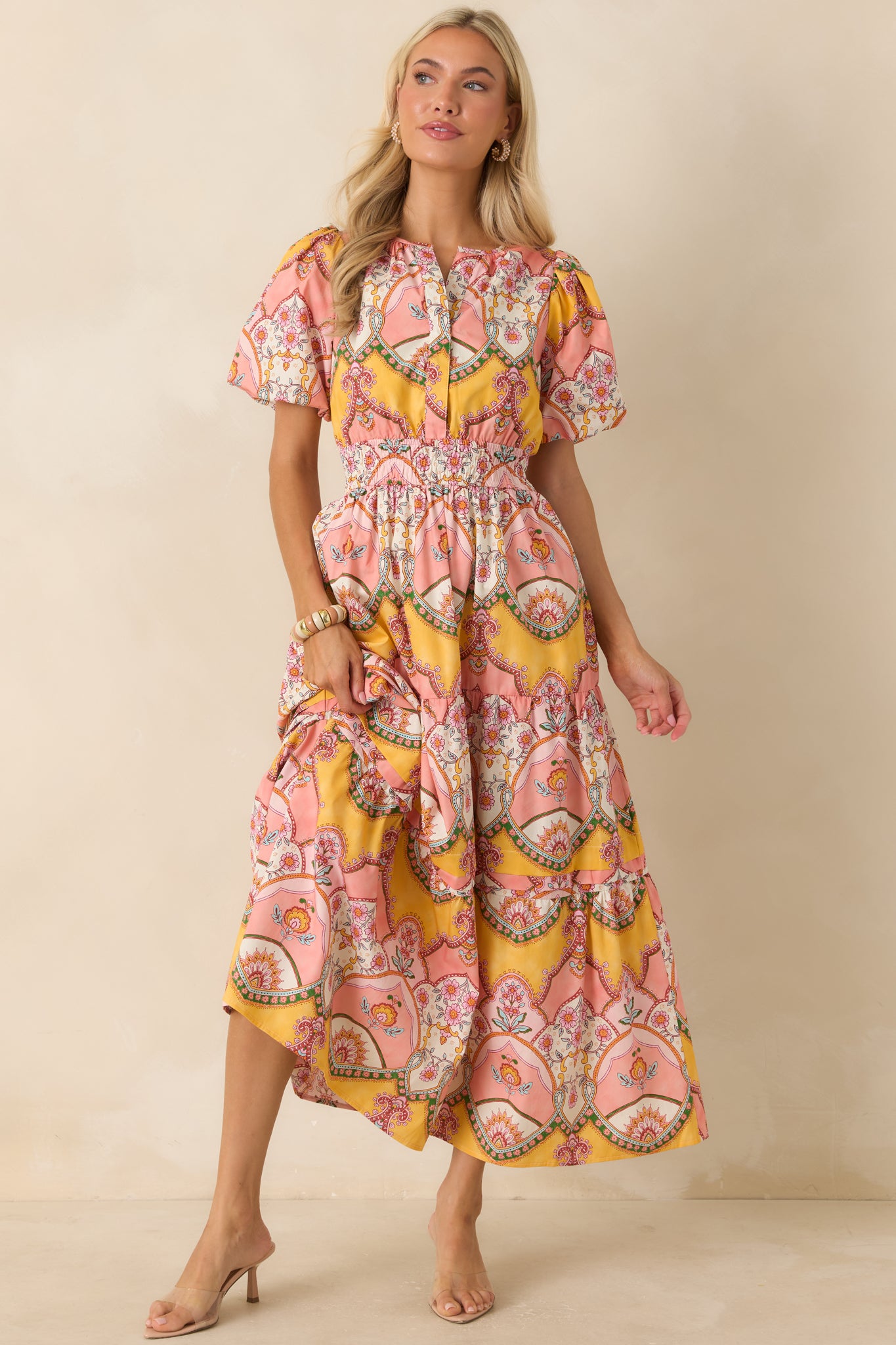 Colorful cotton midi dress highlighting the detailed print placement, front snap placket, and flowing skirt with tiered construction.