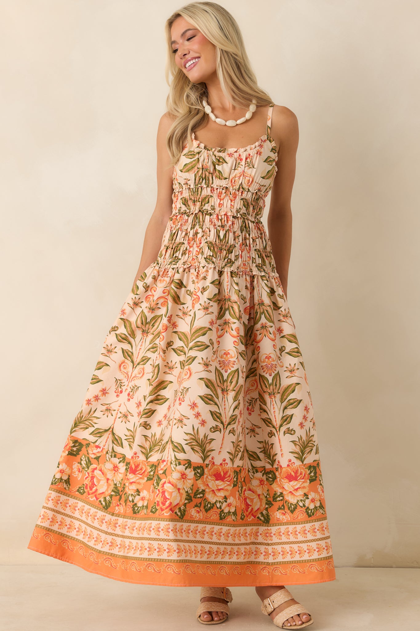 Floral cotton maxi dress with a ruffle-trimmed neckline, vintage-inspired botanical print, and full-length design.