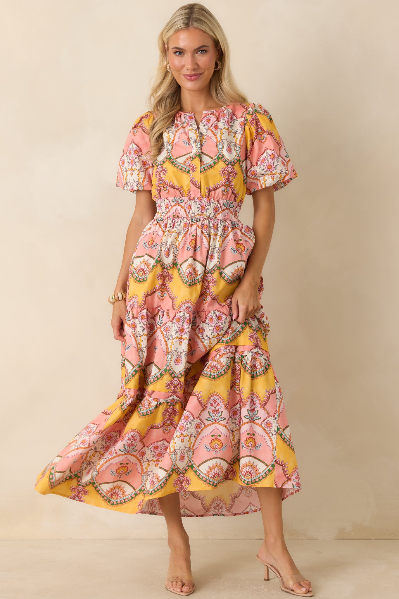 Vintage-inspired scarf-print midi dress featuring vibrant ornamental motifs, side pockets, and a breezy midi-length silhouette.