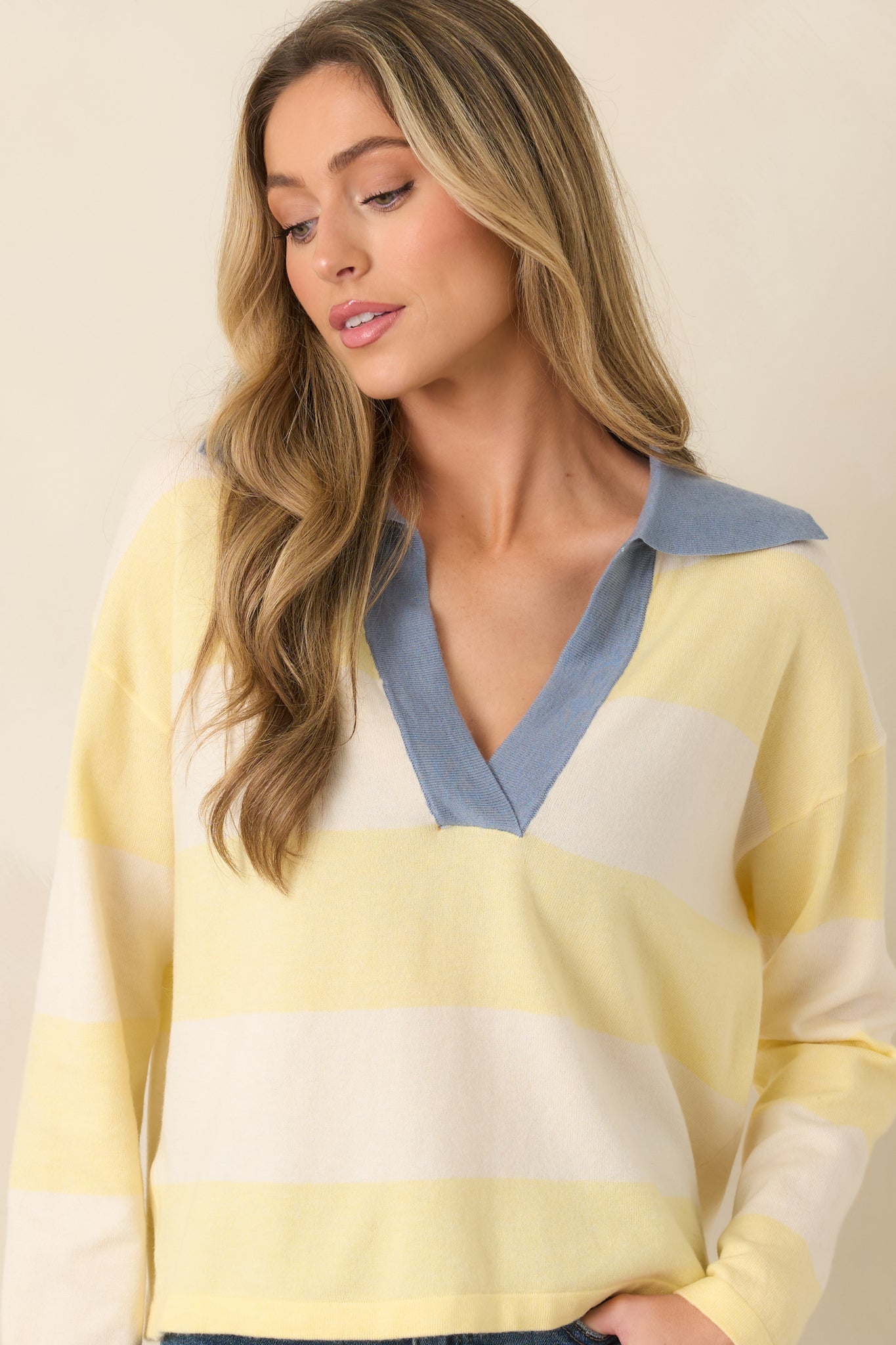Close view of striped sweater with relaxed drape and collar detail