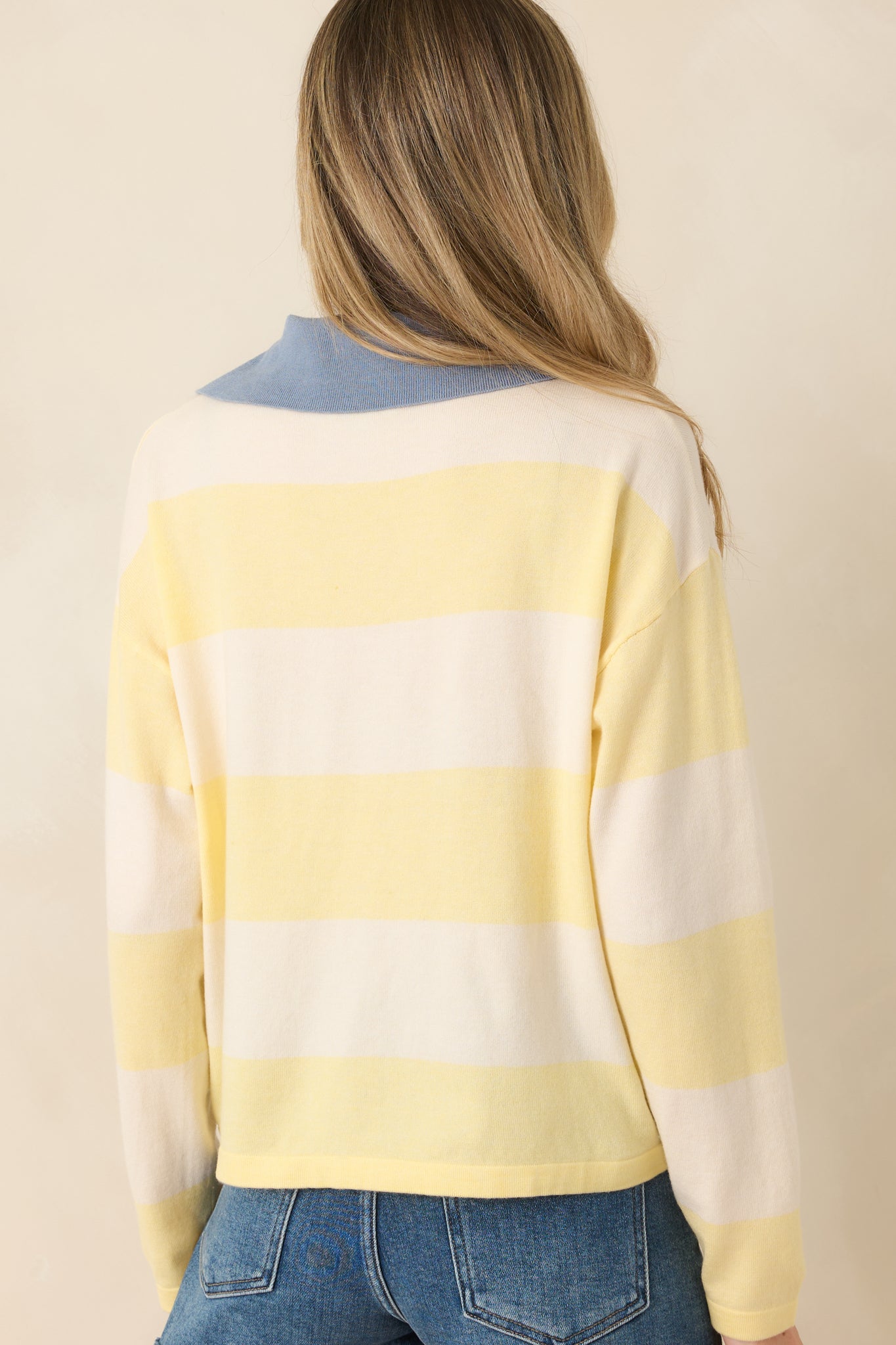 Rear view of striped sweater with relaxed fit and soft knit texture